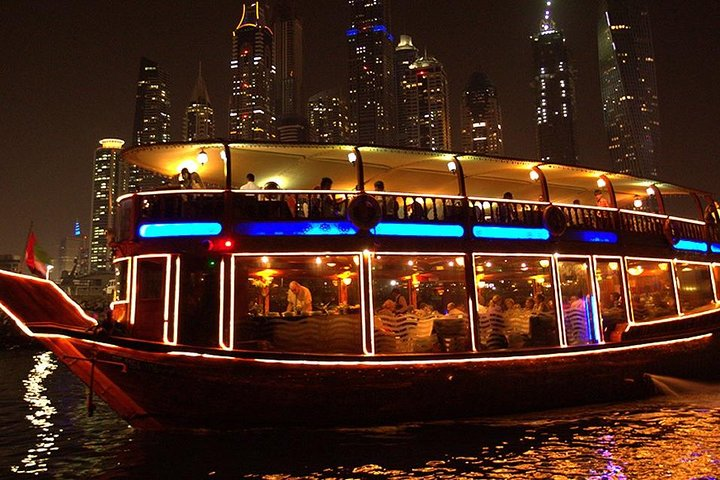Experience the stunning Dubai skyline from a traditional dhow cruise featuring an international buffet dinner entertainment and breathtaking views of iconic landmarks like the Atlantis Hotel and Palm Jumeirah.